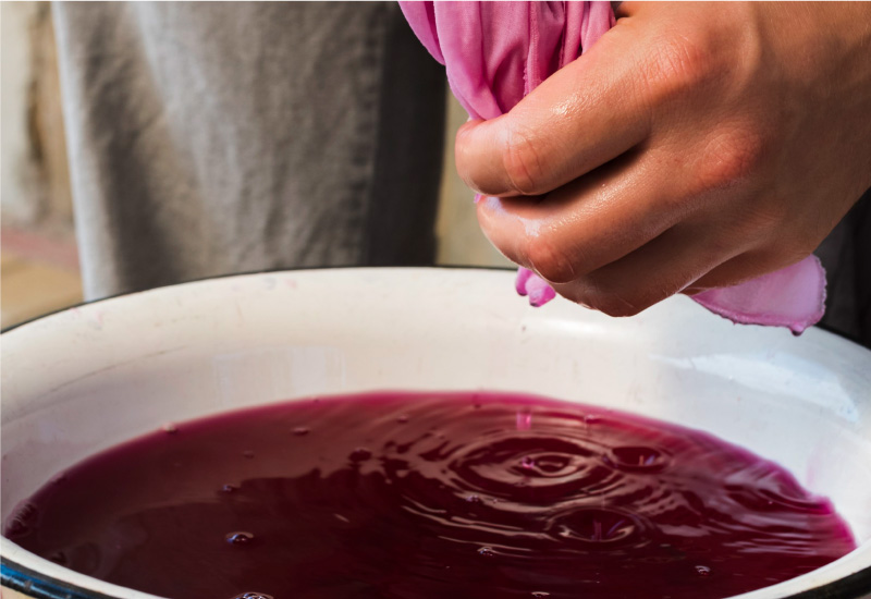 A person is dyeing a clothes