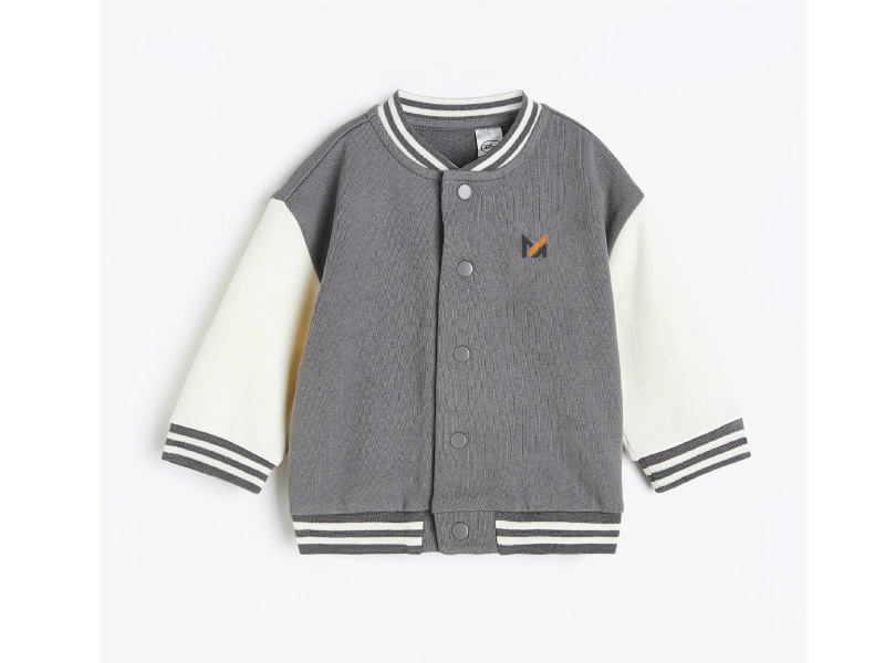 A gray and white baseball jacket with white sleeves and a Mega Apparel logo on the front