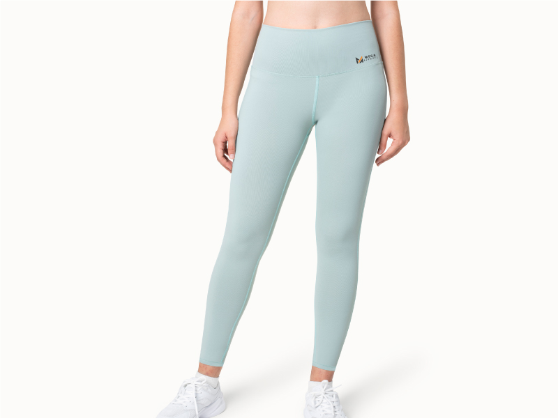 A woman wearing custom light blue leggings and white sneakers