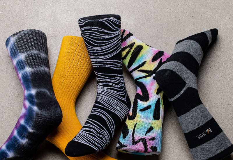 A pair of custom socks with the text Mega apparel on them